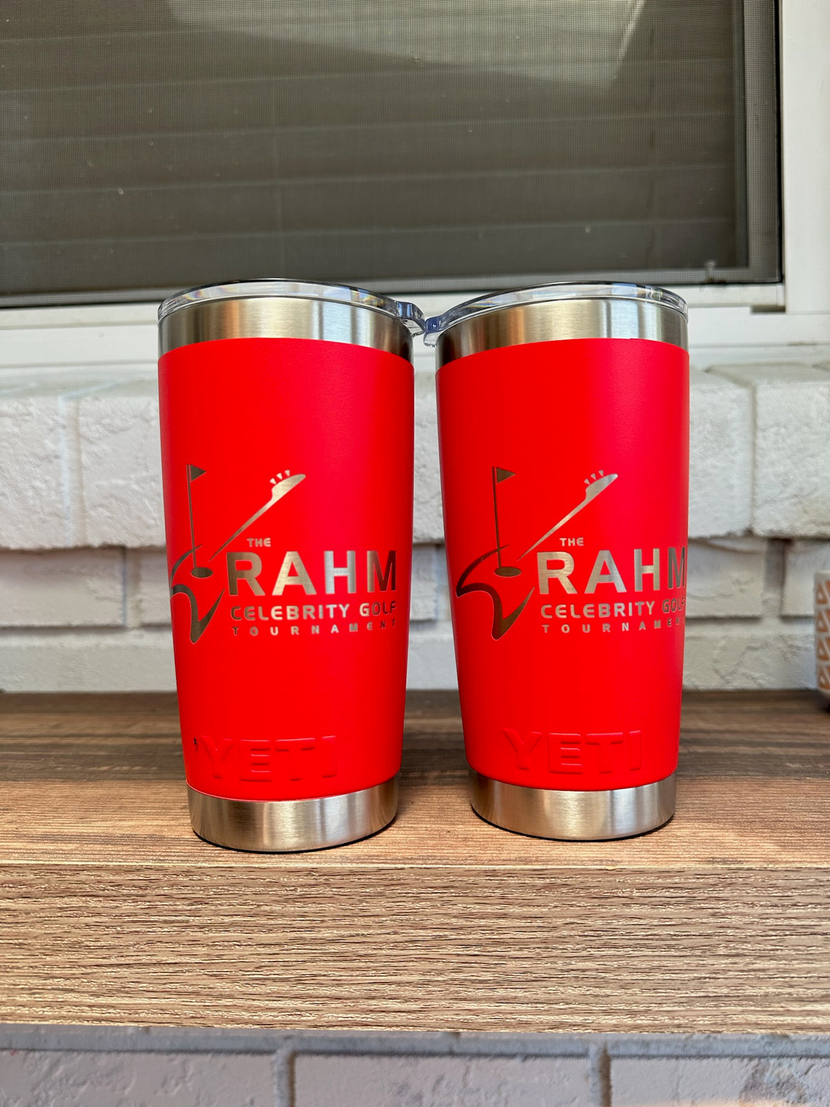Golf tournament logo laser engraved on two Rescue Red YETI Rambler 20 oz Tumblers