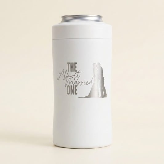 White BRR Ware 3-in-1 can cooler with the satin silver THE Almost Married ONE design and kissing couple silhouette on a clean ivory background. Digital engraving example created with Google Product Studio.