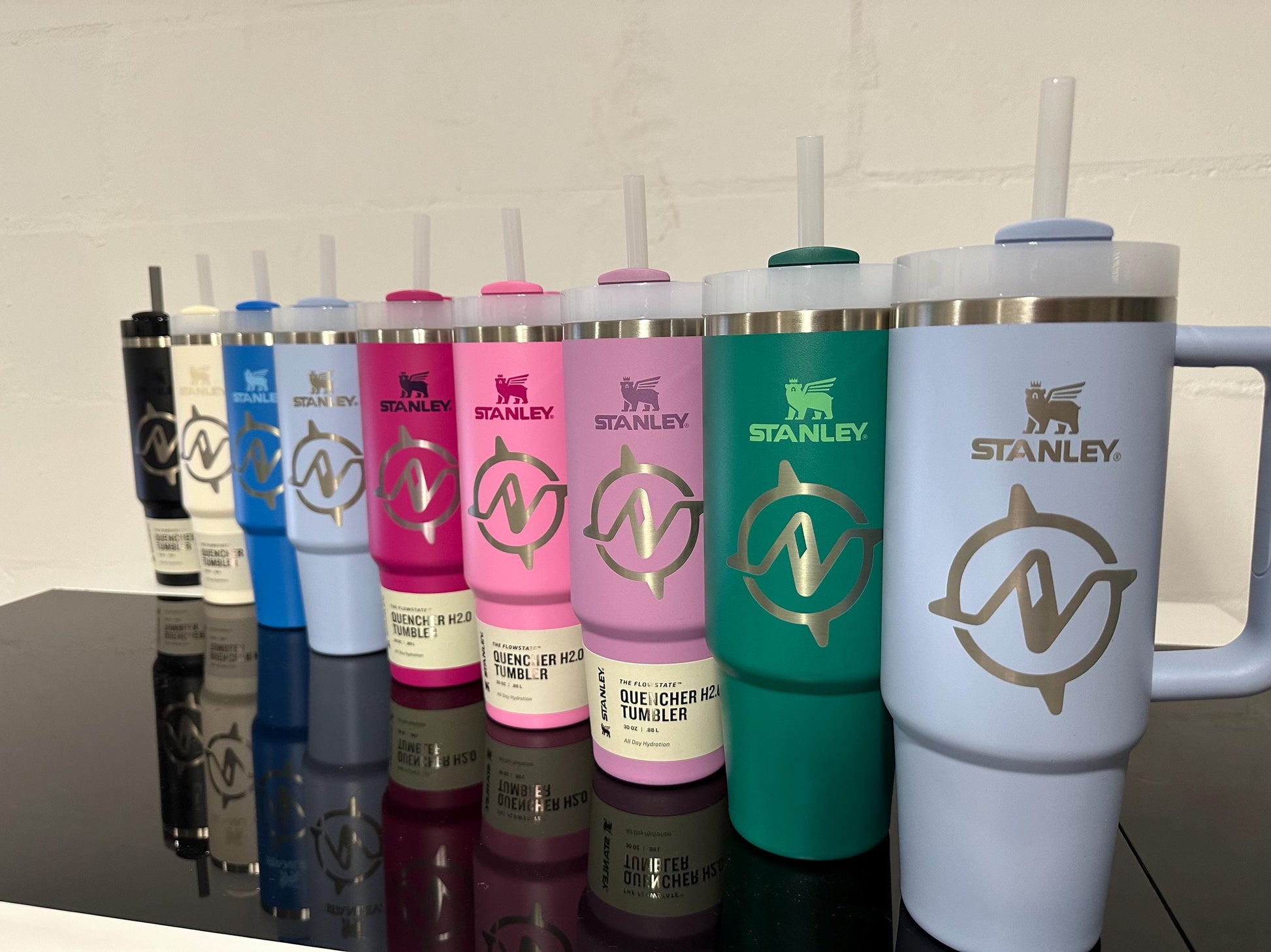The same company logo engraved on Stanley Quenchers in eight different colors
