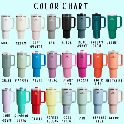 Stanley tumbler color chart displaying 24 different colors of Stanley Quencher cups. The tumblers are arranged in rows against a light blue background, showcasing a variety of shades. Colors include White, Cream, Rose Quartz, Ash, Black, Blue Spruce, Balsam Glow, Alpine, Shale, Matcha, Azure, Lilac, Peony Pink, Fuchsia, Tiger Lily, Nectarine, Sour Grape, Gumdrop Green, Chilli, Pomelo Yellow, Cool Serene, Mint, Heather Blue, and Bloom.