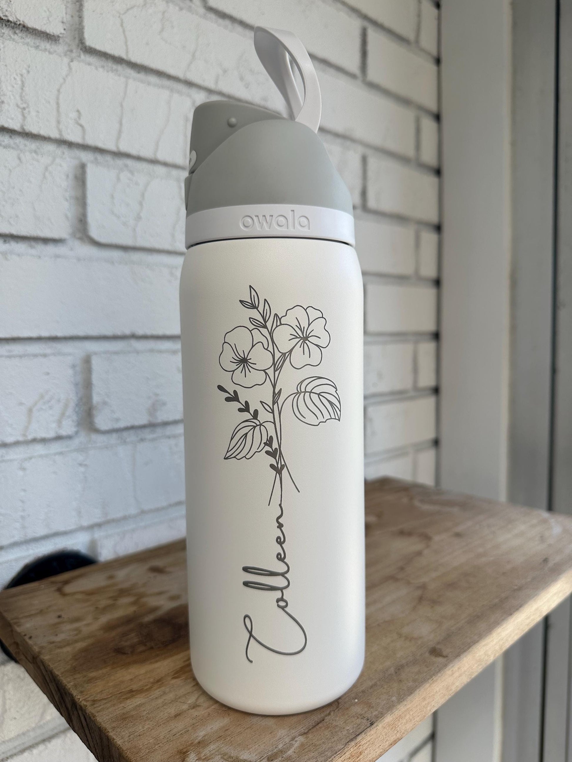 Personalized birth flower Owala FreeSip held in hand