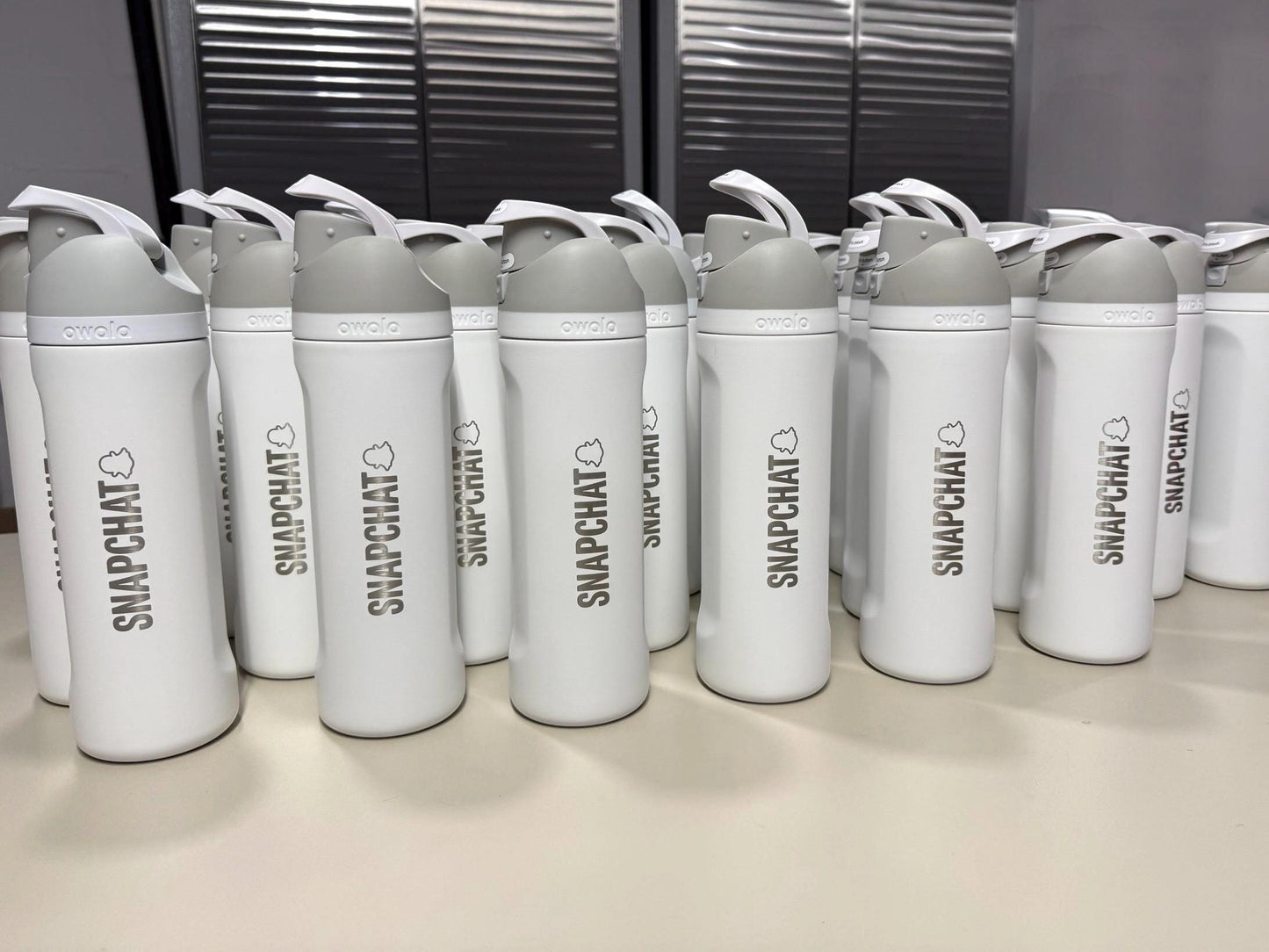 Company logo engraved on a batch of Owala FreeSip bottles