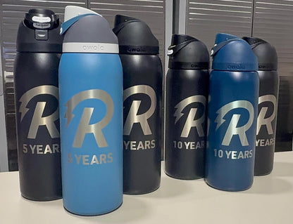 Service anniversary bottles engraved with a company logo and years of service