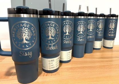 Company logo and individual staff names engraved on dark Stanley Quenchers