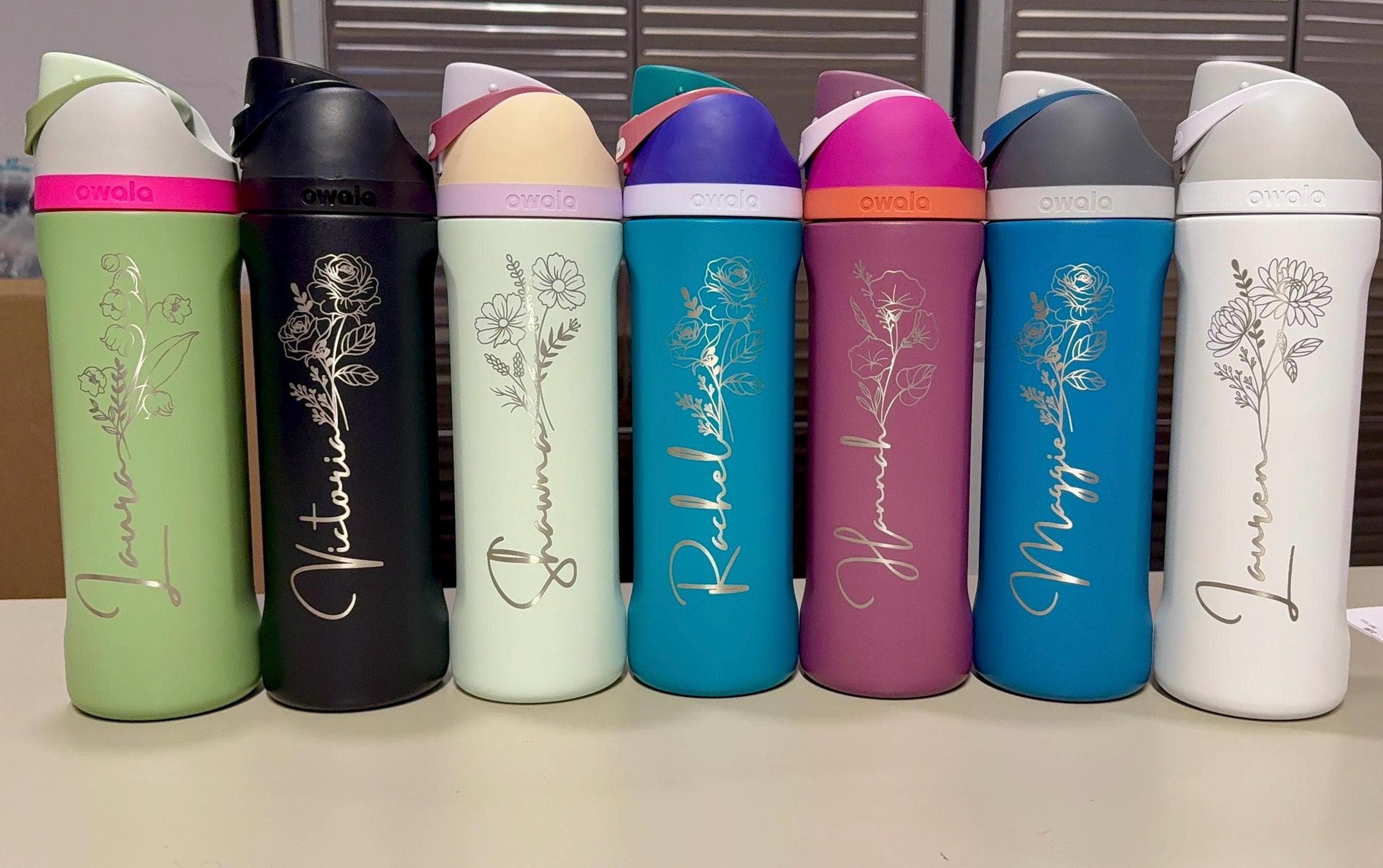 Engraved Owala FreeSip bottles with birth flowers