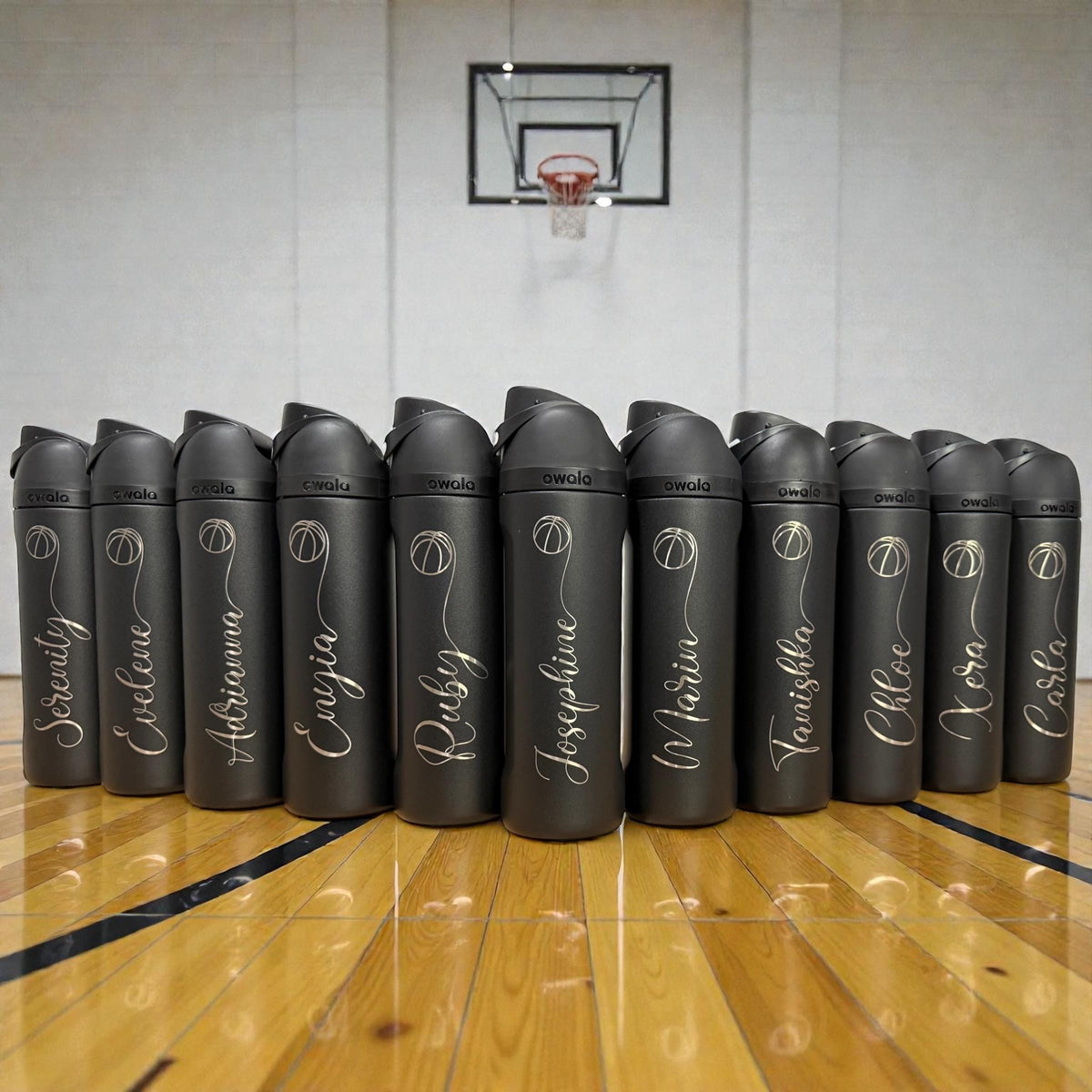 An Owala FreeSip bottle engraved with a sport design and a name
