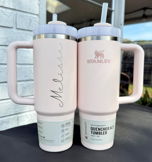 Rose Quartz Stanley Quencher tumblers showing a vertically engraved Melissa name and the original Stanley front.