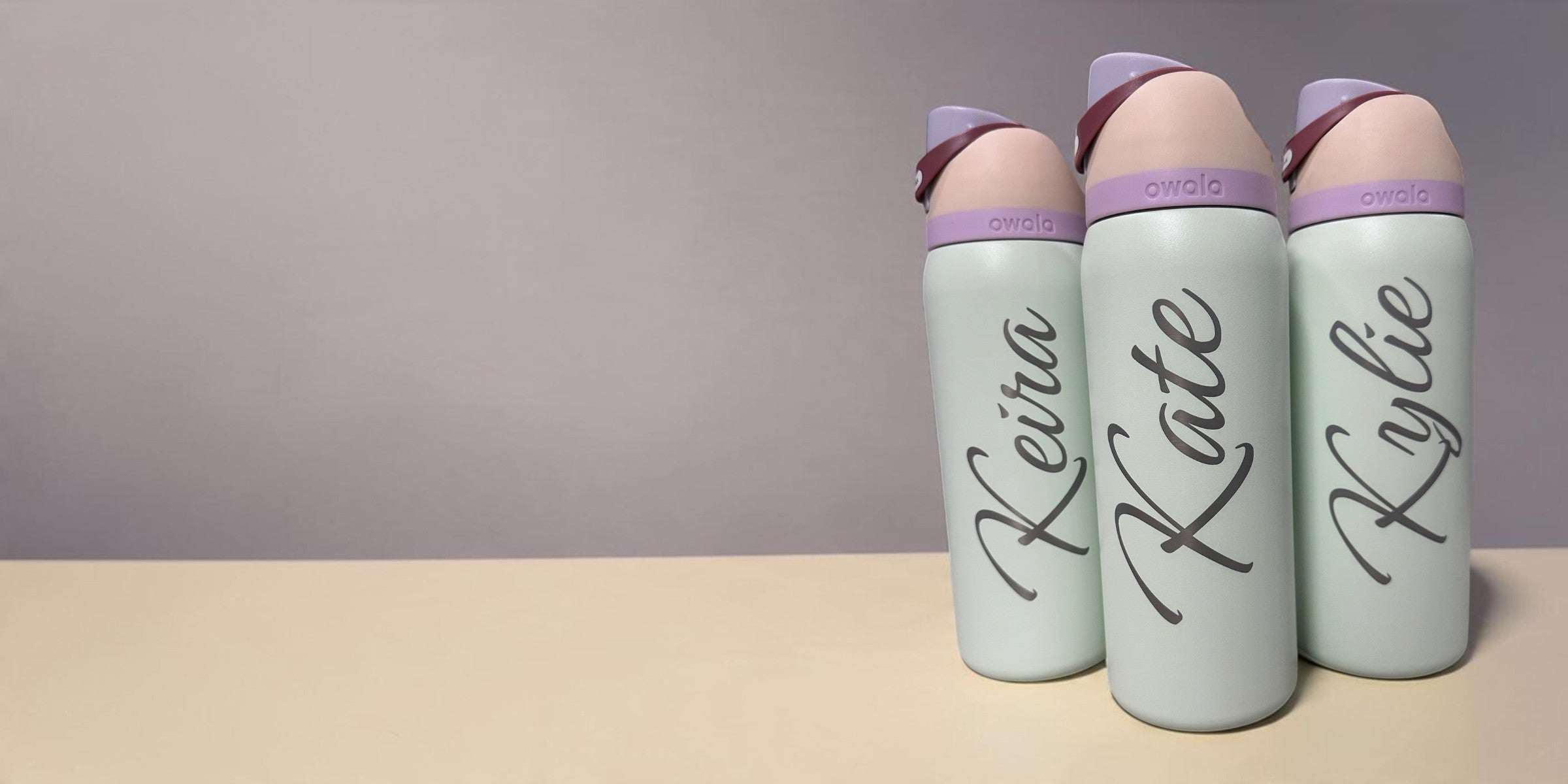 Three mint Owala FreeSip bottles with large engraved names Keira, Kate and Kylie and lavender lids