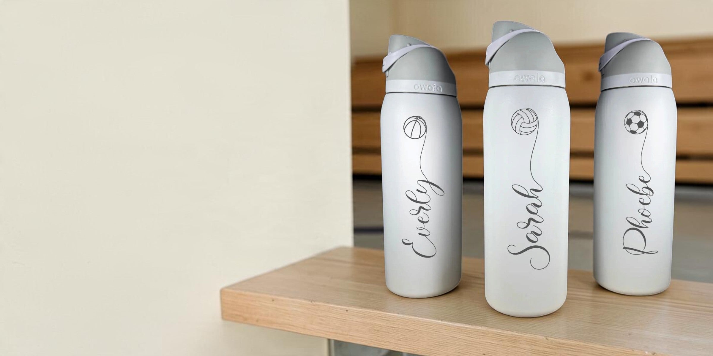 Real Owala FreeSip bottles engraved with sports designs and individual names